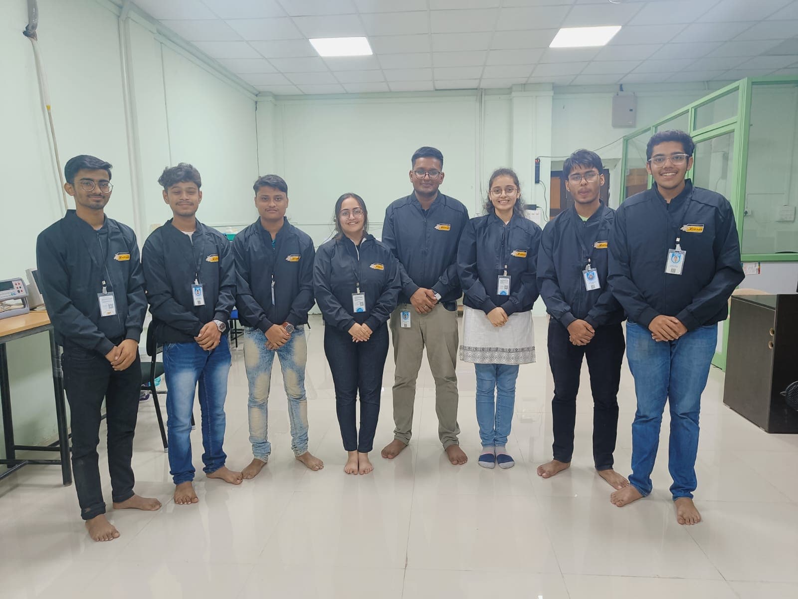 InDhanPay team in branded uniform — engineers, designers, and operations